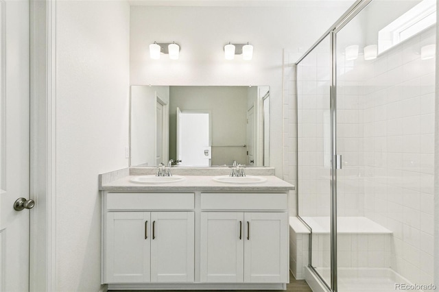 bathroom with walk in shower and vanity