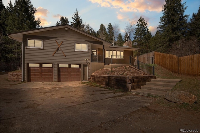 993 Fall River Rd, Idaho Springs, CO 80452 - view of front of property featuring an attached garage, driveway, and fence