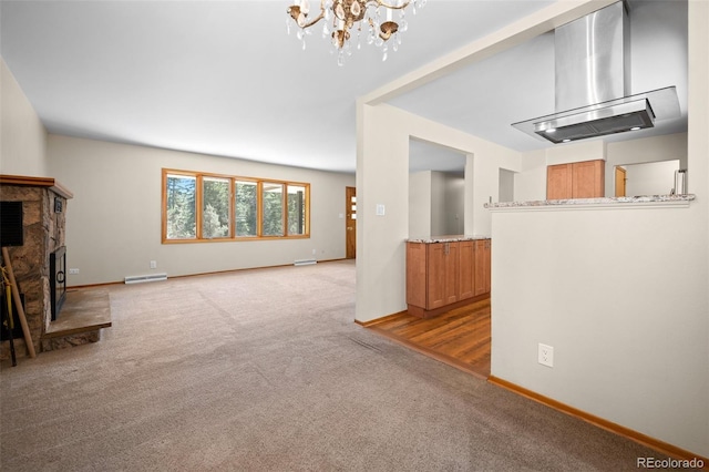 993 Fall River Rd, Idaho Springs, CO 80452 - unfurnished living room with baseboard heating, a fireplace with raised hearth, carpet floors, baseboards, and a notable chandelier