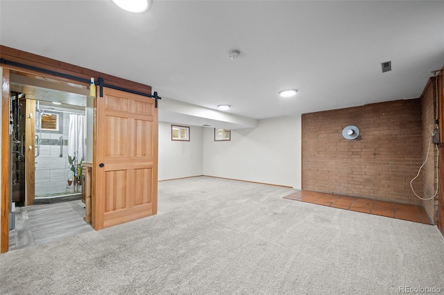 993 Fall River Rd, Idaho Springs, CO 80452 - basement with brick wall, a healthy amount of sunlight, and carpet flooring