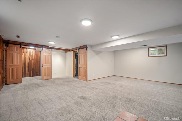 993 Fall River Rd, Idaho Springs, CO 80452 - finished basement with baseboards, visible vents, carpet floors, and a barn door