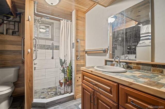 993 Fall River Rd, Idaho Springs, CO 80452 - bathroom featuring wood ceiling, toilet, vanity, and a stall shower
