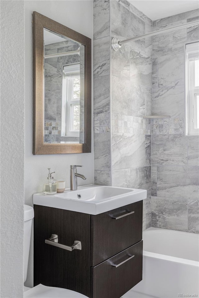 424 N Clarkson St, Denver, CO 80218 - bathroom with healthy amount of natural light, vanity, toilet, and bathtub / shower combination