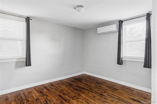 424 N Clarkson St, Denver, CO 80218 - empty room featuring a wall mounted air conditioner, baseboards, dark wood-style floors, and healthy amount of natural light