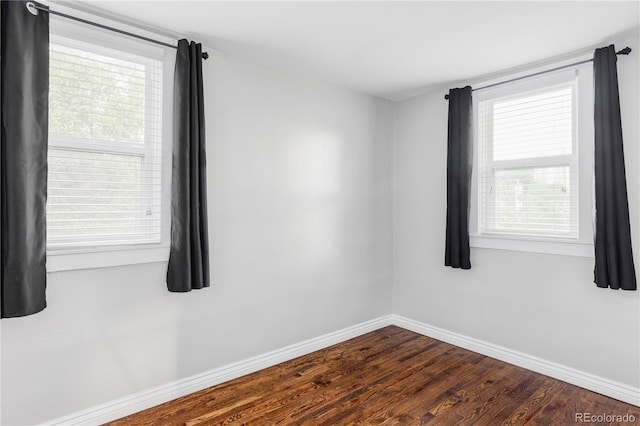 424 N Clarkson St, Denver, CO 80218 - empty room featuring baseboards, dark wood-type flooring, and plenty of natural light