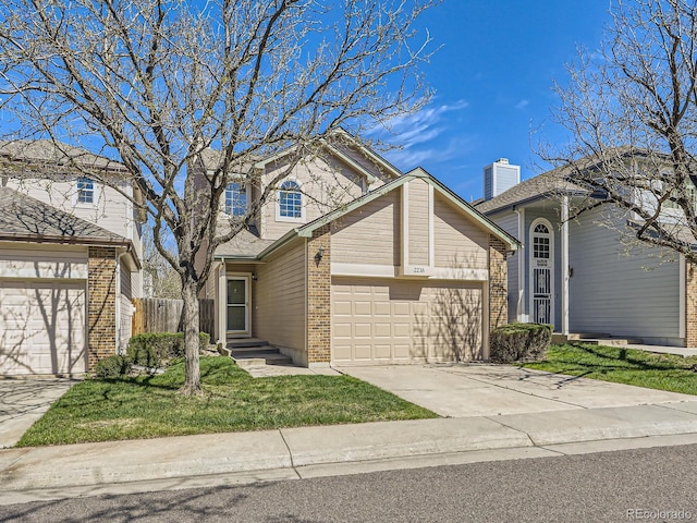 traditional home featuring fence, brick siding, driveway, a garage, and a front yard