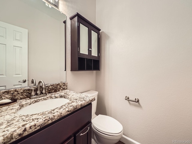 bathroom with toilet and vanity
