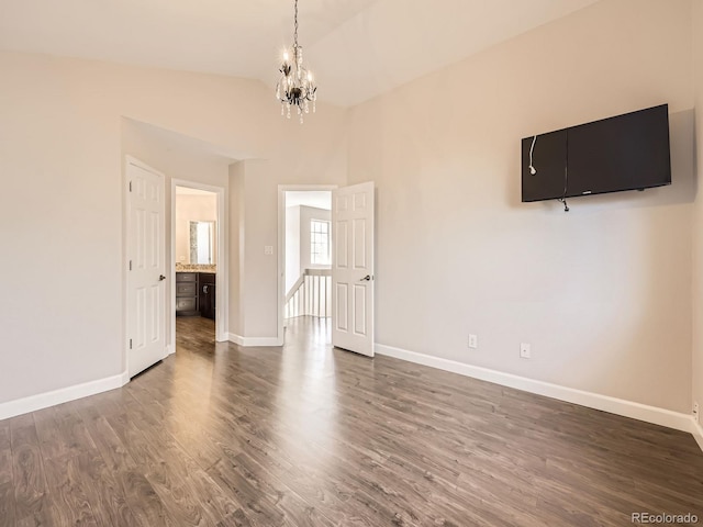 interior space with baseboards, dark wood-style flooring, and an inviting chandelier