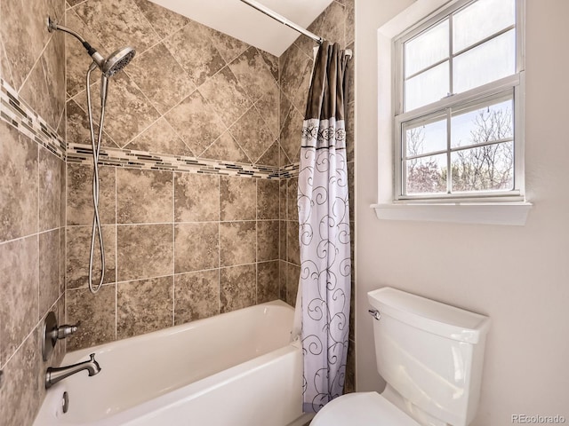 bathroom with toilet and shower / bath combo