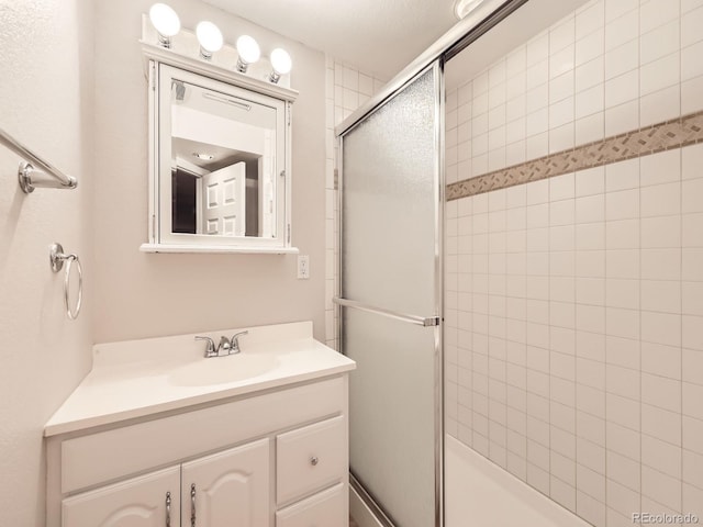bathroom featuring vanity and a tile shower