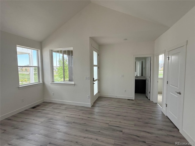 6113 Zebulon Pl, Timnath, CO 80547 - spare room with wood finished floors, baseboards, and high vaulted ceiling
