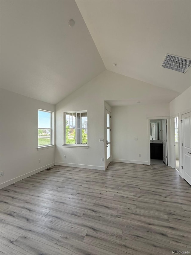 6113 Zebulon Pl, Timnath, CO 80547 - unfurnished living room featuring lofted ceiling, wood finished floors, and baseboards