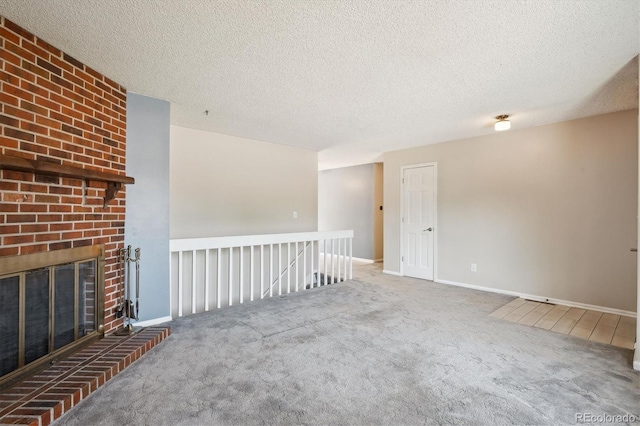 800 Park View Pl, Castle Rock, CO 80104 - unfurnished living room featuring carpet, a fireplace, baseboards, and a textured ceiling