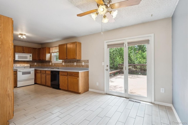 800 Park View Pl, Castle Rock, CO 80104 - kitchen with white appliances, tasteful backsplash, a sink, brown cabinetry, and baseboards