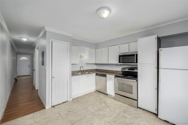 kitchen with white cabinetry, ornamental molding, stainless steel appliances, and sink