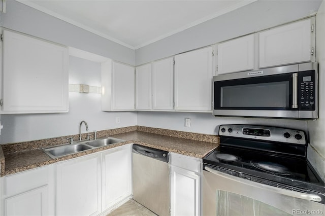 kitchen featuring white cabinetry, ornamental molding, stainless steel appliances, and sink