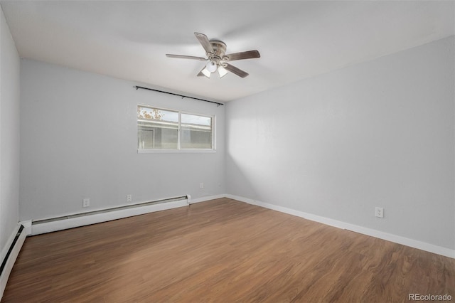 empty room featuring wood-type flooring, ceiling fan, and baseboard heating