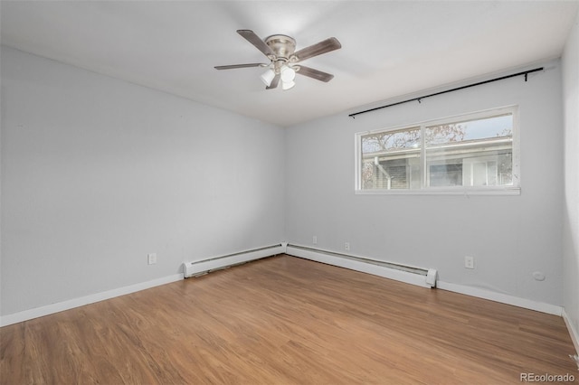 empty room featuring a baseboard heating unit, light hardwood / wood-style flooring, and ceiling fan