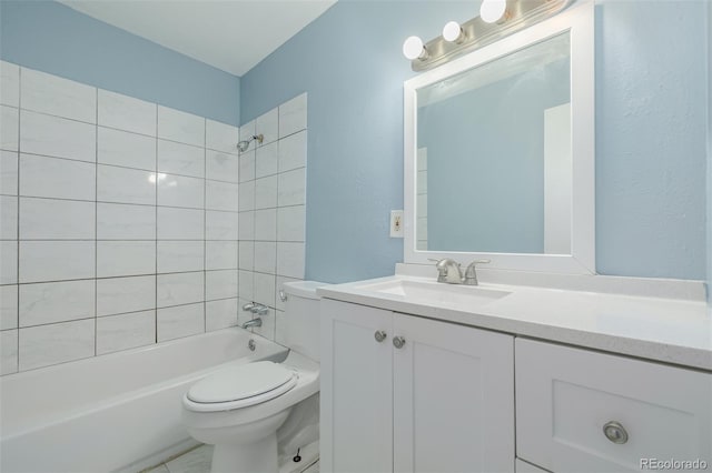 full bathroom featuring tiled shower / bath combo, vanity, and toilet