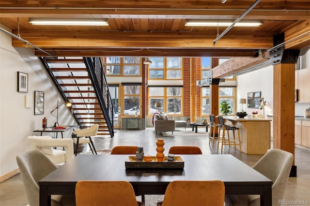 dining room featuring beamed ceiling and wooden ceiling