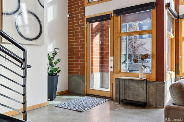 doorway to outside with concrete floors