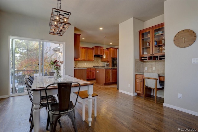 dining space with dark hardwood / wood-style flooring