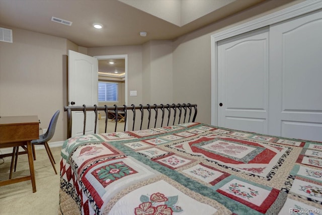 bedroom featuring a closet and light colored carpet