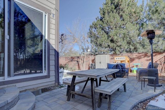 view of patio featuring a storage unit