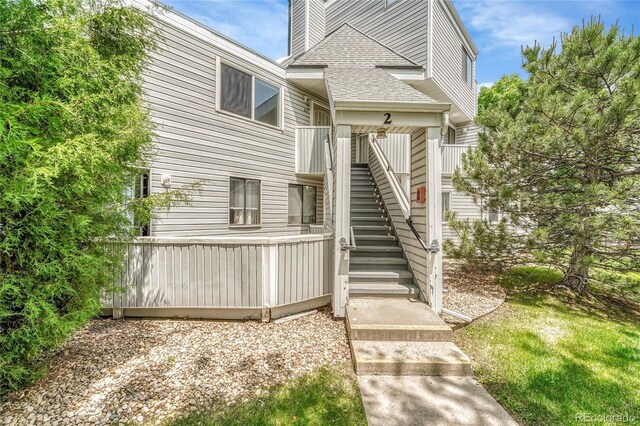 8701 Huron St Unit 211, Thornton, CO 80260 - back of property featuring stairs and roof with shingles