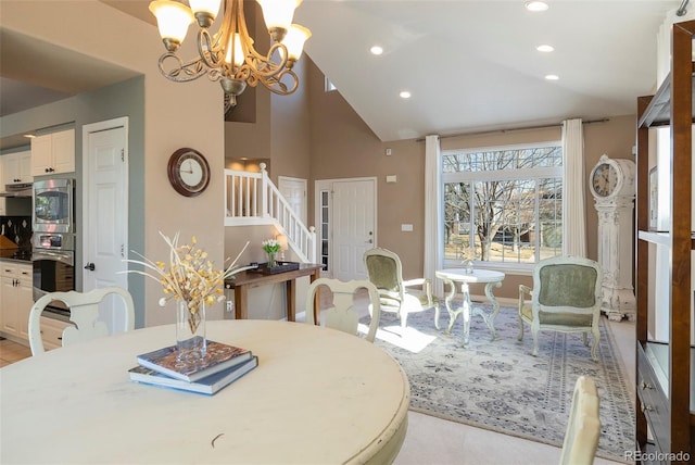 dining space featuring vaulted ceiling and a chandelier