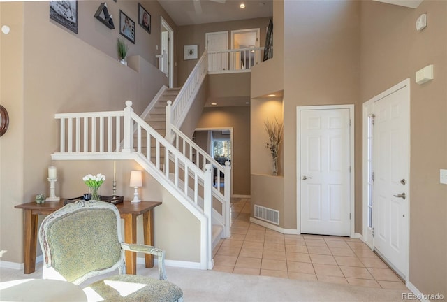 tiled foyer with a towering ceiling