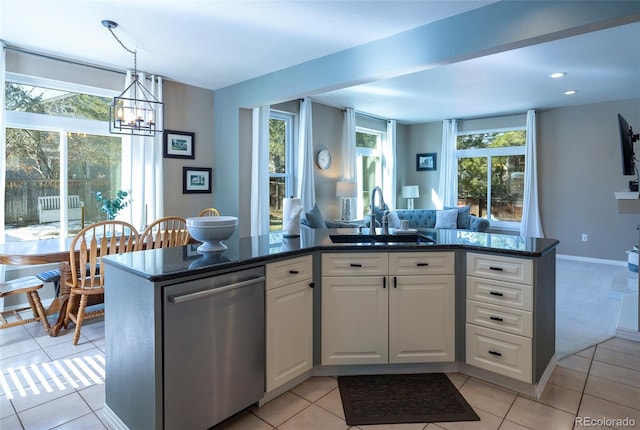 kitchen featuring decorative light fixtures, dishwasher, sink, white cabinets, and light tile patterned floors