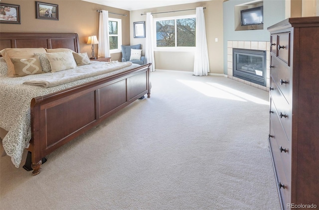 carpeted bedroom featuring a fireplace