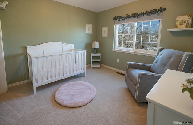 bedroom with a nursery area and light colored carpet