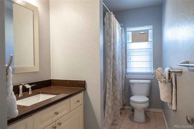 bathroom featuring tile patterned flooring, vanity, a shower with shower curtain, and toilet