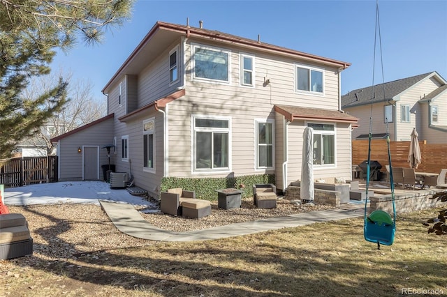 rear view of house with central air condition unit and a patio area