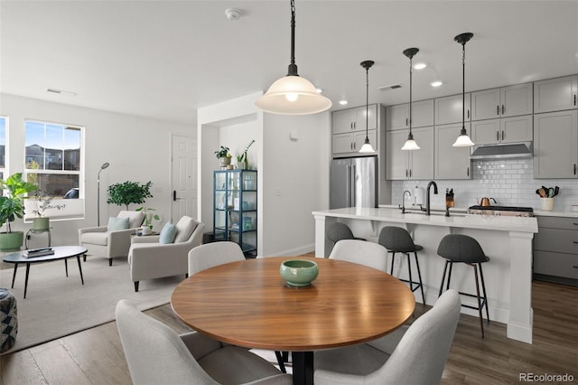 dining room featuring dark hardwood / wood-style flooring and sink