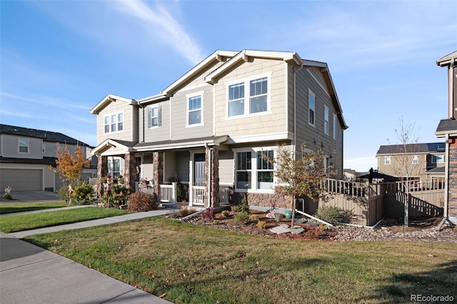 craftsman-style home with covered porch and a front lawn