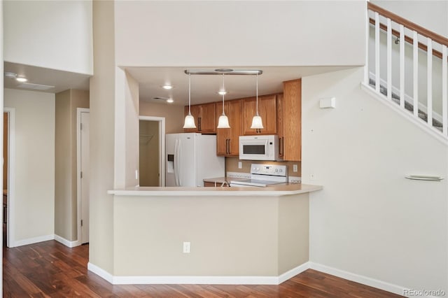 5600 W 3rd St Unit S, Greeley, CO 80634 - kitchen with white appliances, brown cabinets, dark wood-type flooring, light countertops, and pendant lighting