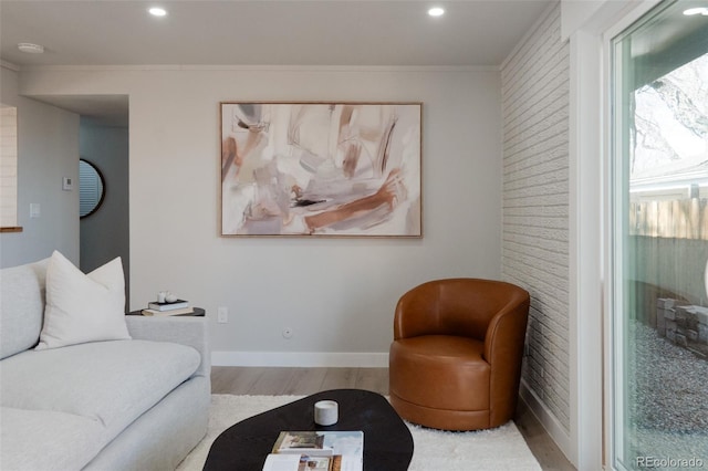 living area with crown molding, recessed lighting, wood finished floors, and baseboards