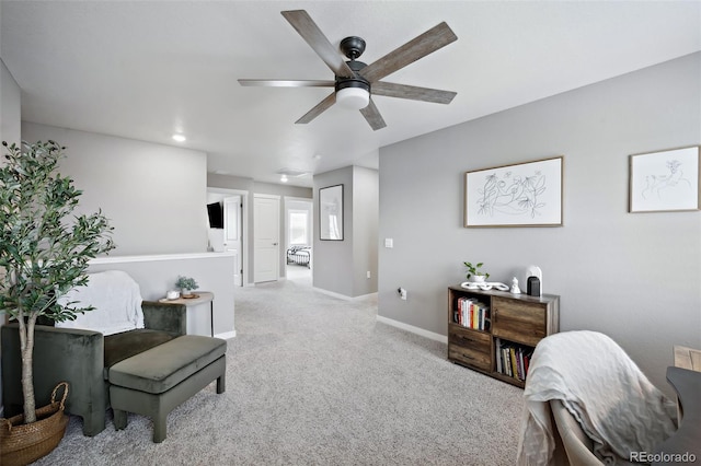 interior space with ceiling fan and light colored carpet