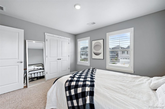 carpeted bedroom with a closet