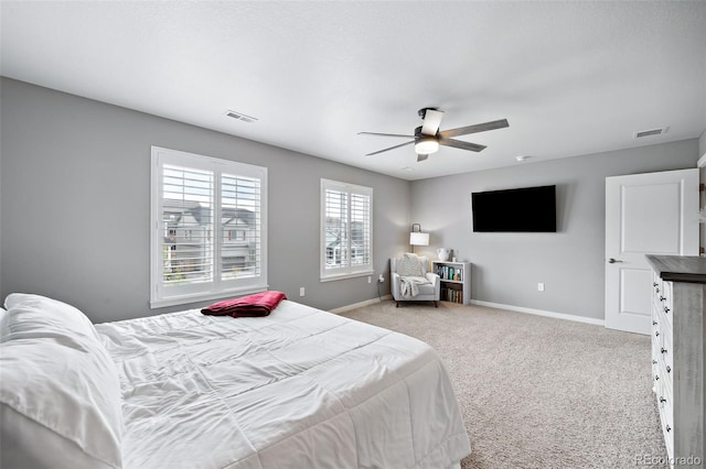 bedroom with ceiling fan and light carpet