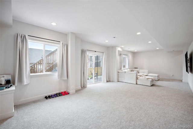 interior space featuring light carpet and a healthy amount of sunlight