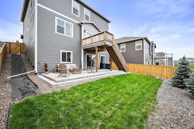 back of house featuring a patio, outdoor lounge area, a deck, and a yard