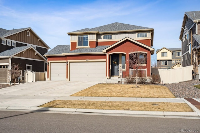 view of front facade with a garage, concrete driveway, roof with shingles, and fence