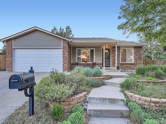 4063 S Cathay Ct, Aurora, CO 80013 - ranch-style home with a porch, brick siding, driveway, and a garage