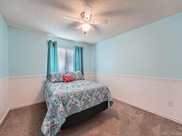4063 S Cathay Ct, Aurora, CO 80013 - bedroom with a textured ceiling, carpet floors, a wainscoted wall, and a ceiling fan