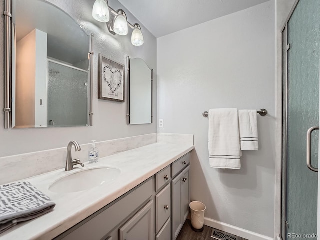 4063 S Cathay Ct, Aurora, CO 80013 - bathroom featuring vanity, a stall shower, and wood finished floors
