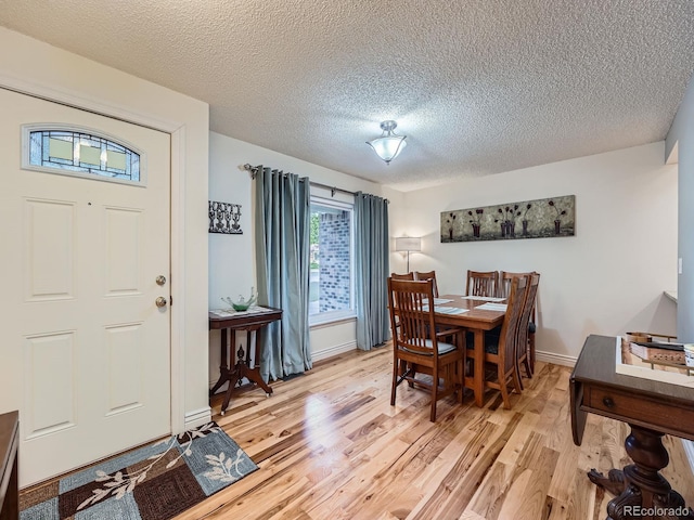 4063 S Cathay Ct, Aurora, CO 80013 - dining area with light wood-style floors and a textured ceiling